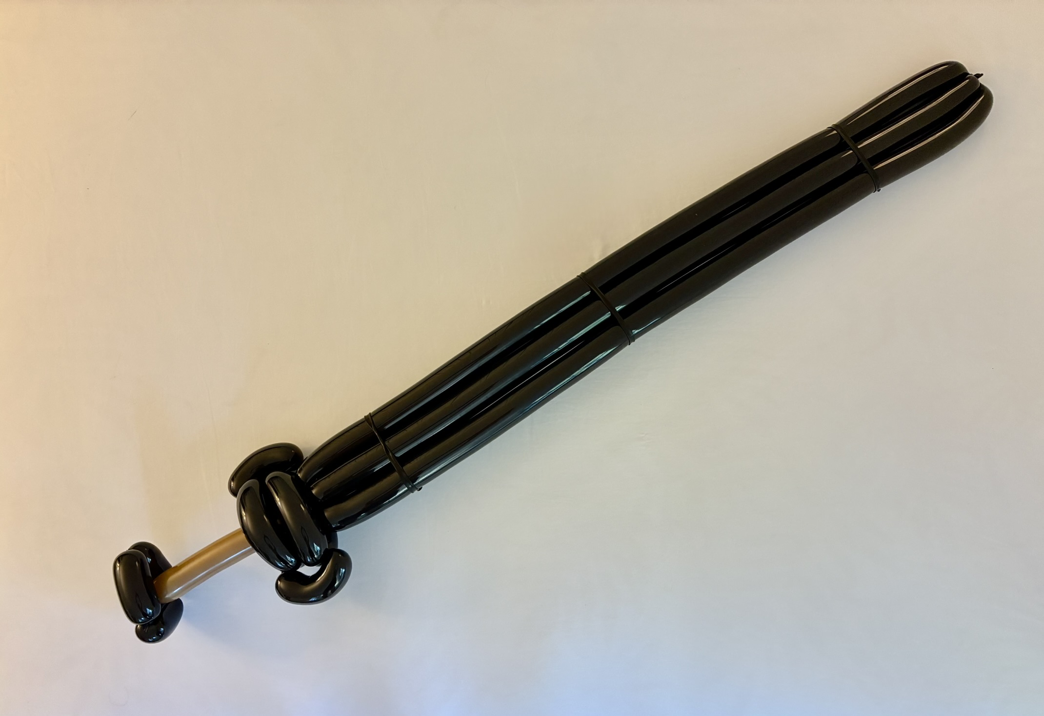 Black balloon sword sculpture