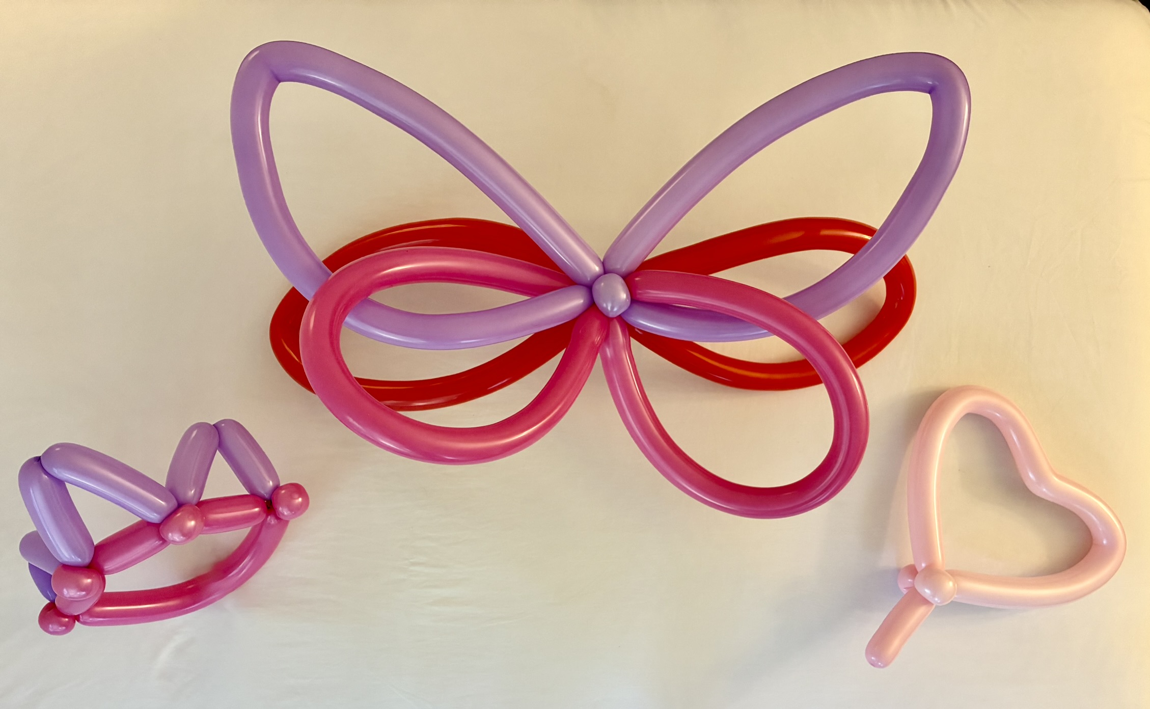 Pink, purple, and red butterfly and heart balloon sculptures