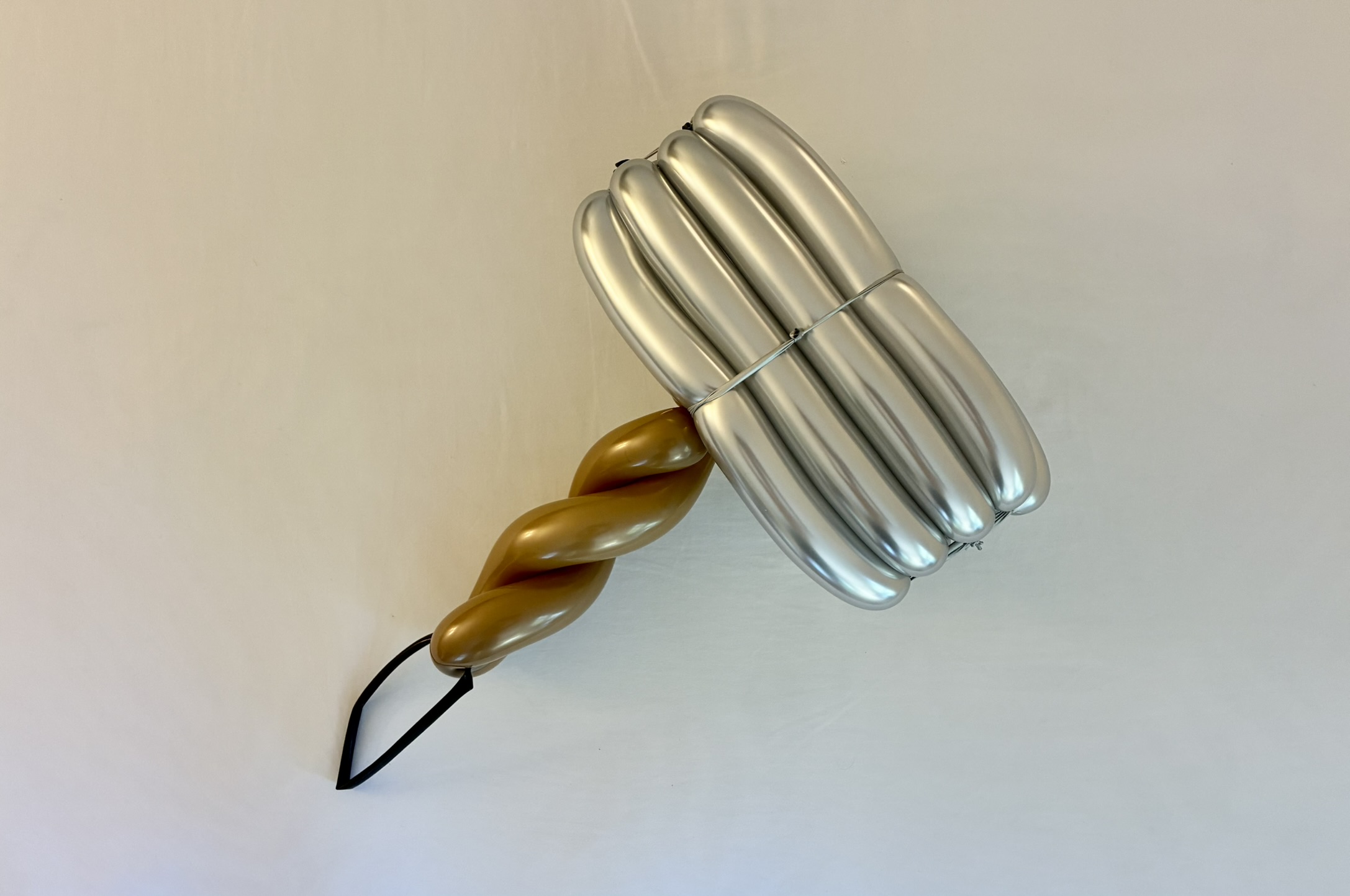 Silver and gold balloon hammer sculpture